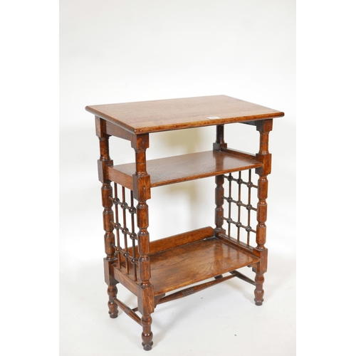 1138 - A Liberty & Co. Arts and Crafts three tier book stand with turned lattice work sides, 23