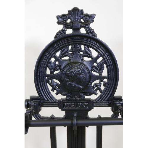 1142 - A C19th style Victory cast iron umbrella stand with cast legs, 32