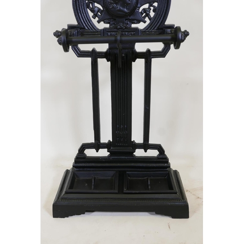 1142 - A C19th style Victory cast iron umbrella stand with cast legs, 32