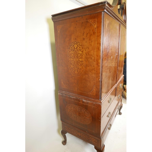 1143 - A C19th plum pudding mahogany press cupboard, with inlaid seaweed panel panels, the upper section wi... 