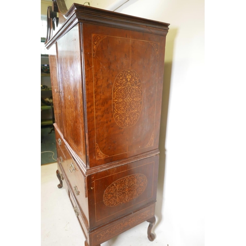 1143 - A C19th plum pudding mahogany press cupboard, with inlaid seaweed panel panels, the upper section wi... 