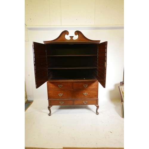 1143 - A C19th plum pudding mahogany press cupboard, with inlaid seaweed panel panels, the upper section wi... 