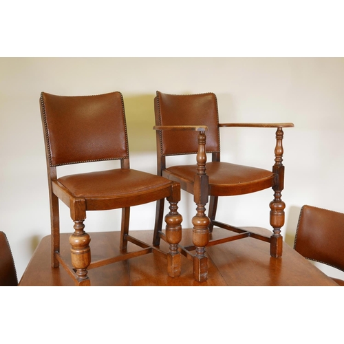 1147 - A Victorian mahogany wind out dining table on turned and carved legs, with a single leaf, and six oa... 