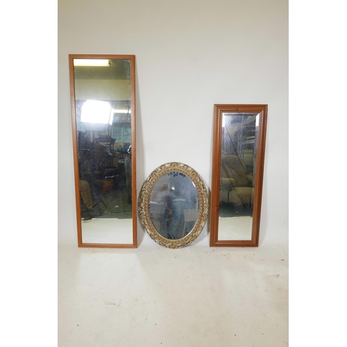 1152 - A gilt composition oval wall mirror and two other hall mirrors, largest 62