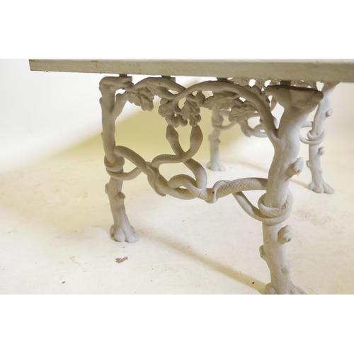 1188 - A C19th painted cast iron bench, with wood top, the ends with entwined serpents and oak branches, co... 