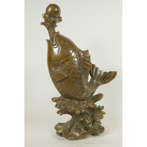 119 - A Chinese bronze figure of a carp supporting a pearl on a water jet, 16