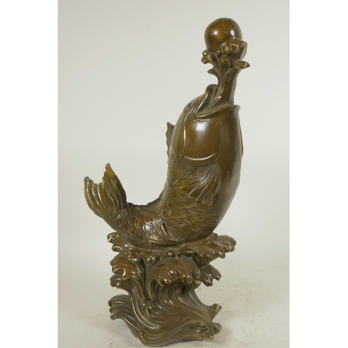 119 - A Chinese bronze figure of a carp supporting a pearl on a water jet, 16