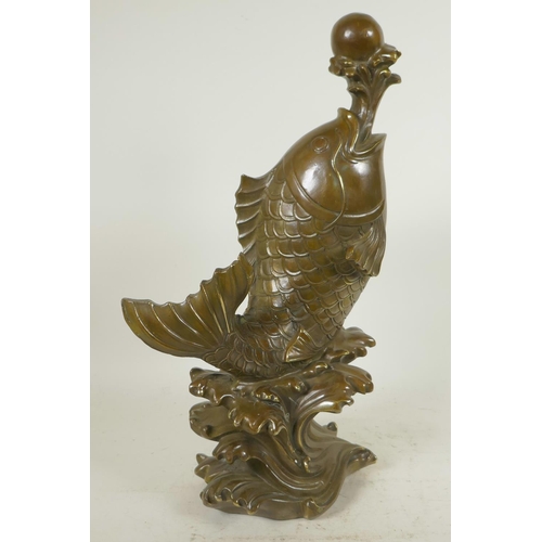 119 - A Chinese bronze figure of a carp supporting a pearl on a water jet, 16