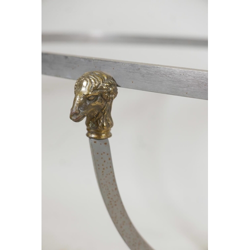 1198 - A brushed steel occasional table with brass ram's mask mounts and hoof feet, 52