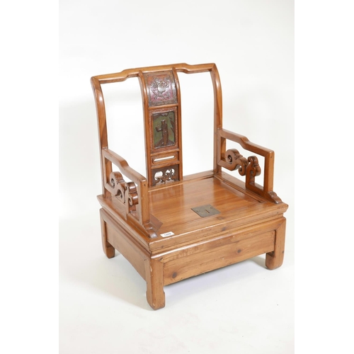 1209 - A Chinese fruitwood low commode chair with carved and painted decoration to the back splat, 21