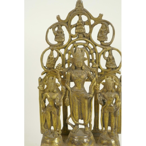 122 - A Chinese gilt bronze figure of three deities standing before a pierced screen decorated with Buddhi... 