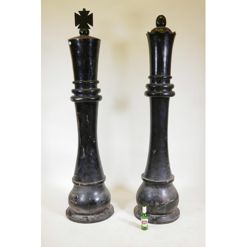 1224 - A pair of giant carved wood 'King and Queen' chess pieces, 72