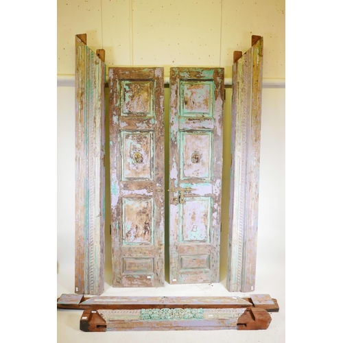 1230 - Architectural salvage: A pair of Indian teak storm doors, with frame, each door with four moulded an... 