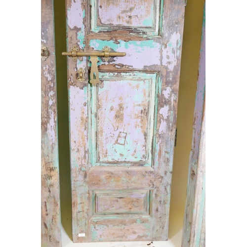 1230 - Architectural salvage: A pair of Indian teak storm doors, with frame, each door with four moulded an... 