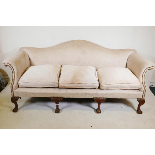 1231 - A Chippendale style humpback settee, with scroll arms, raised on carved cabriole supports with claw ... 