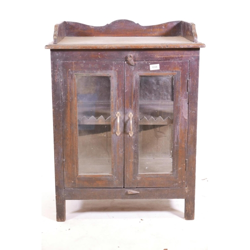 1238 - An Indian teak two door cabinet with glazed doors and sides (one glass missing), and a three quarter... 