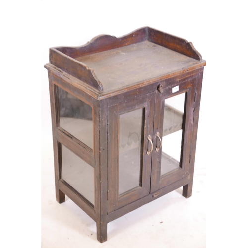 1238 - An Indian teak two door cabinet with glazed doors and sides (one glass missing), and a three quarter... 