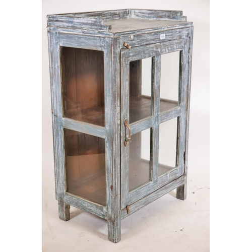 1239 - An Indian hardwood single door display cabinet with three quarter gallery top and glazed sides, rais... 