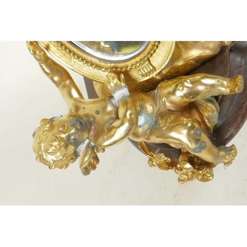 124 - A gilt bronze table mirror in the form of a lute with cherubs, on a marble base, 12