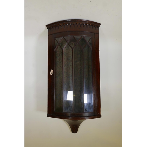 1242 - A Georgian mahogany bowfront hanging corner display cabinet, with arched top and single astragal gla... 