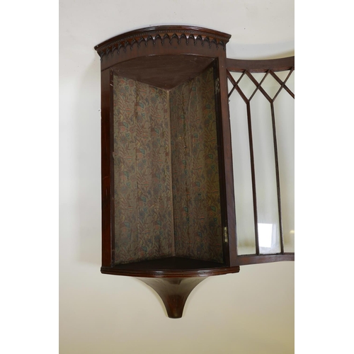 1242 - A Georgian mahogany bowfront hanging corner display cabinet, with arched top and single astragal gla... 