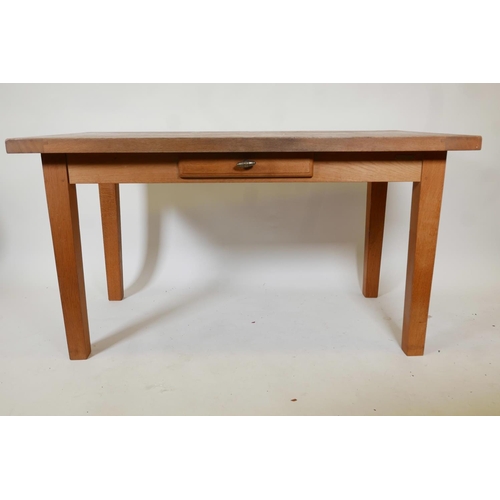 1243 - A contemporary oak dining table with single drawer, raised on tapering detachable supports,  55