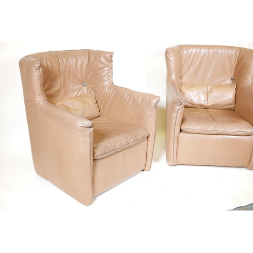 1255 - A pair of retro 1970s leather wing back armchairs, 36