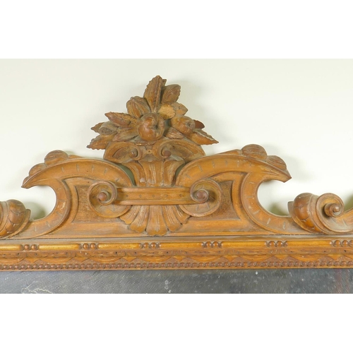 1265 - A C19th satin walnut framed wall mirror with carved and pierced crest, 36