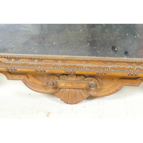 1265 - A C19th satin walnut framed wall mirror with carved and pierced crest, 36