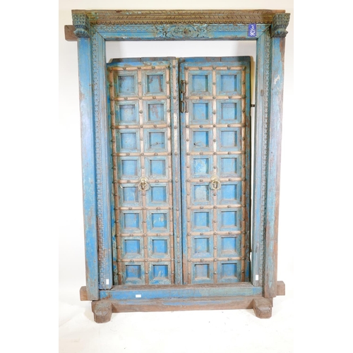 1267 - Architectural salvage: A pair of Indian hardwood panelled storm doors, with brass sheathed iron stra... 