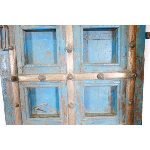 1267 - Architectural salvage: A pair of Indian hardwood panelled storm doors, with brass sheathed iron stra... 