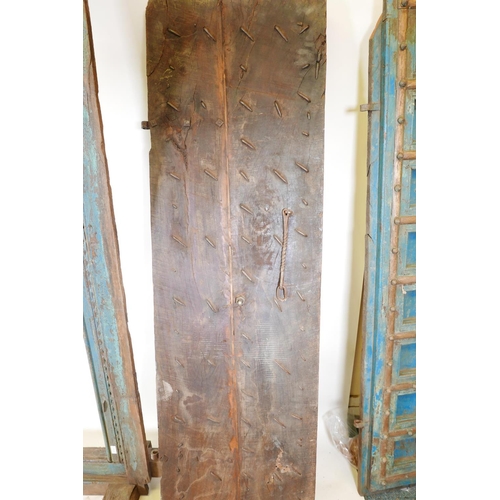 1267 - Architectural salvage: A pair of Indian hardwood panelled storm doors, with brass sheathed iron stra... 