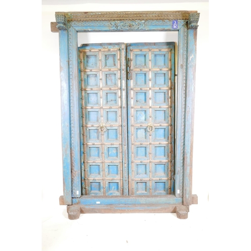 1267 - Architectural salvage: A pair of Indian hardwood panelled storm doors, with brass sheathed iron stra... 