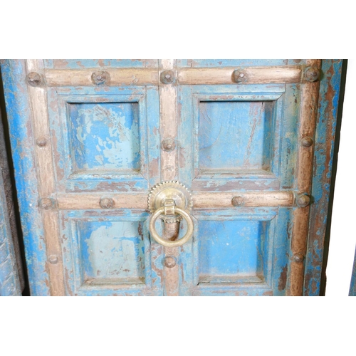 1267 - Architectural salvage: A pair of Indian hardwood panelled storm doors, with brass sheathed iron stra... 