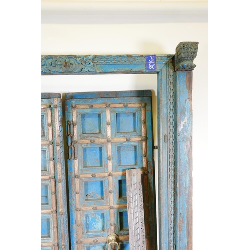 1267 - Architectural salvage: A pair of Indian hardwood panelled storm doors, with brass sheathed iron stra... 