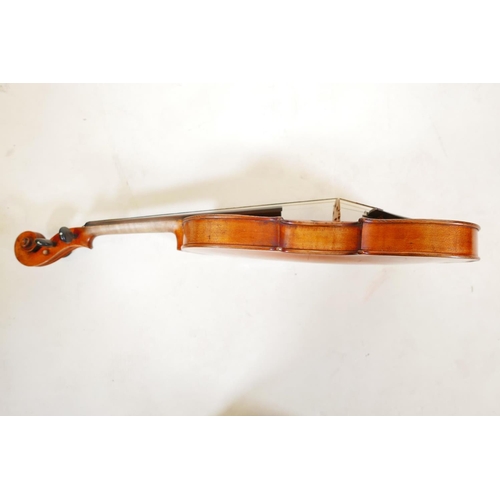 129 - A late C19th/early C20th violin in ebonised wood case, no label, one piece back, split to front, and... 