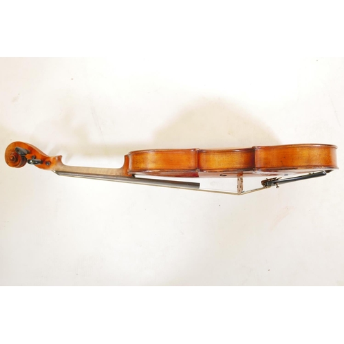 129 - A late C19th/early C20th violin in ebonised wood case, no label, one piece back, split to front, and... 