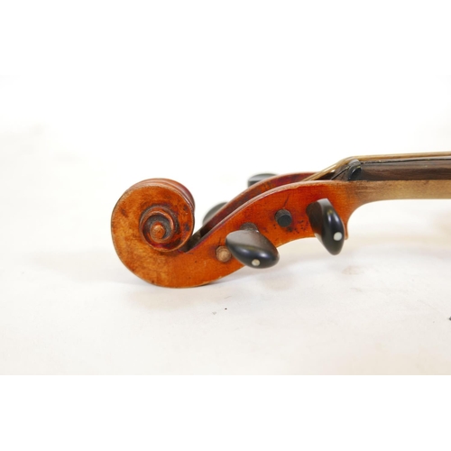 129 - A late C19th/early C20th violin in ebonised wood case, no label, one piece back, split to front, and... 