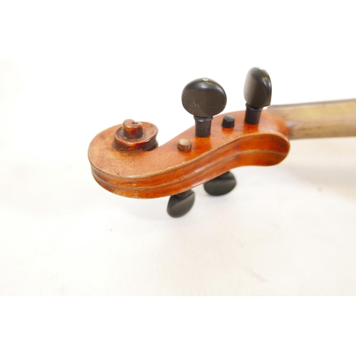 129 - A late C19th/early C20th violin in ebonised wood case, no label, one piece back, split to front, and... 