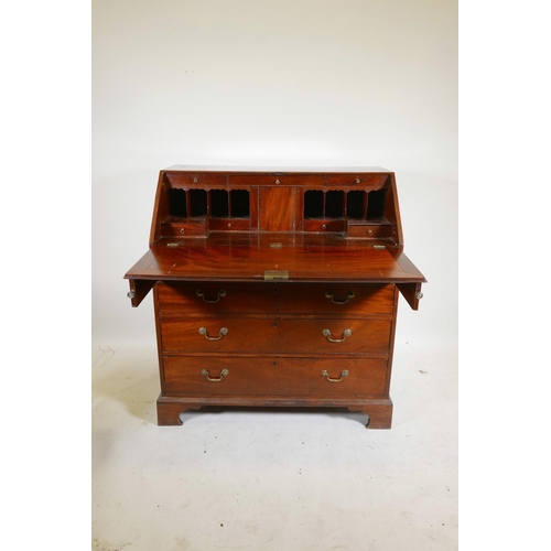 1290 - A Georgian mahogany fall front bureau, the fitted interior with secret drawer and slides over four l... 