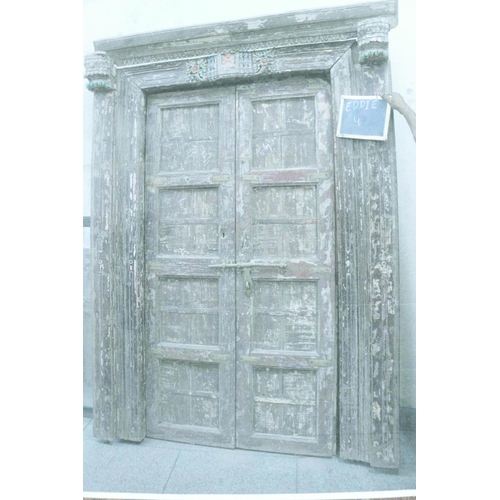 1292 - Architectural salvage: A pair of Indian teak storm doors and frame, with carved details, each door w... 