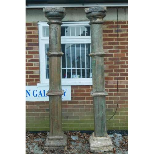 1301 - Architectural Salvage: A pair of Indian painted teak columns with carved capitals, mounted on carved... 