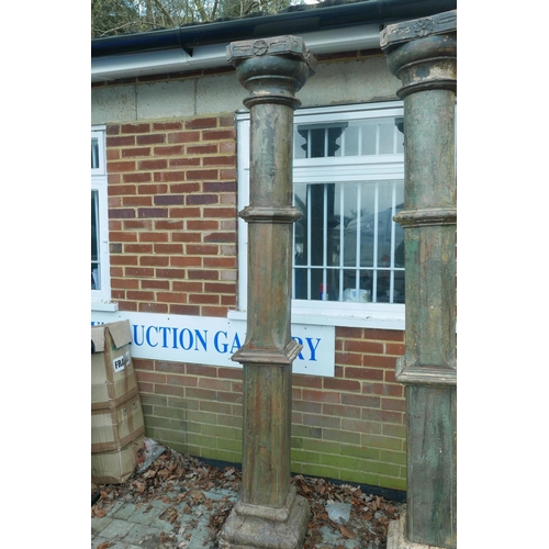 1301 - Architectural Salvage: A pair of Indian painted teak columns with carved capitals, mounted on carved... 