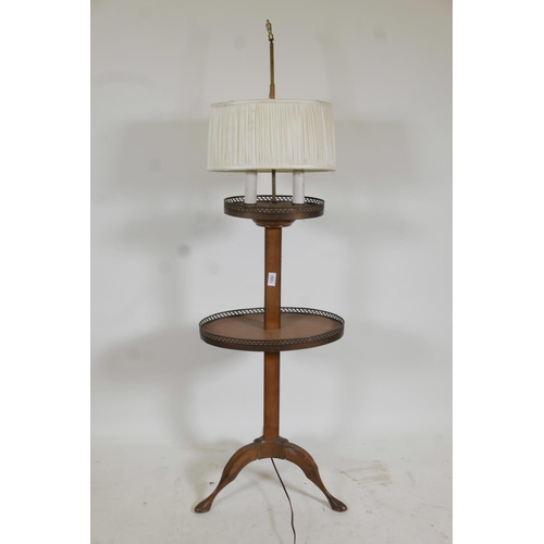 1302 - A mahogany lamp table with pierced galleries, raised on tripod supports, 55