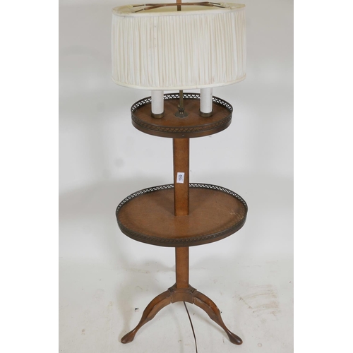 1302 - A mahogany lamp table with pierced galleries, raised on tripod supports, 55