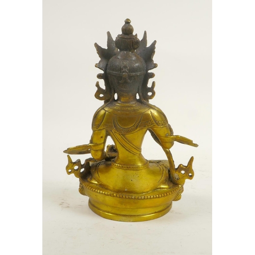 133 - A Sino-Tibetan gilt metal Buddha seated on a lotus throne, double vajra mark to base, 8