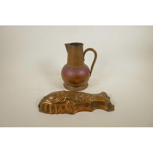 141 - An Arts and Crafts copper jug, together with a coppered metal jelly mould in the form of a fish, 9