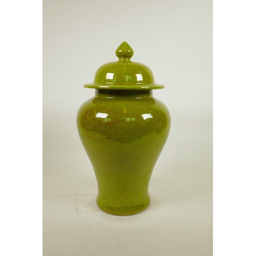 143 - A Chinese lime green crackle glazed porcelain baluster jar and cover, 14