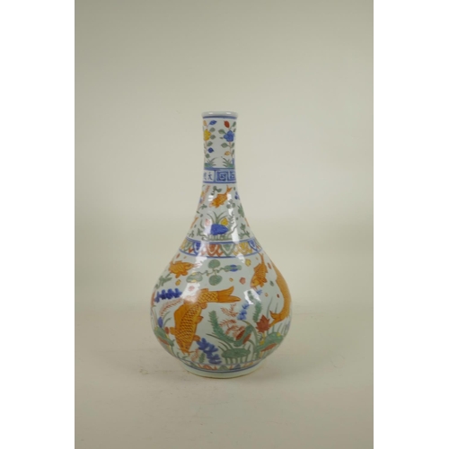 148 - A Chinese Wucai porcelain bottle vase decorated with carp in a lotus pond, 6 character mark to neck,... 