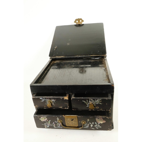 149 - A Japanese black lacquer vanity box with three drawers and mirror compartment extensively inlaid wit... 